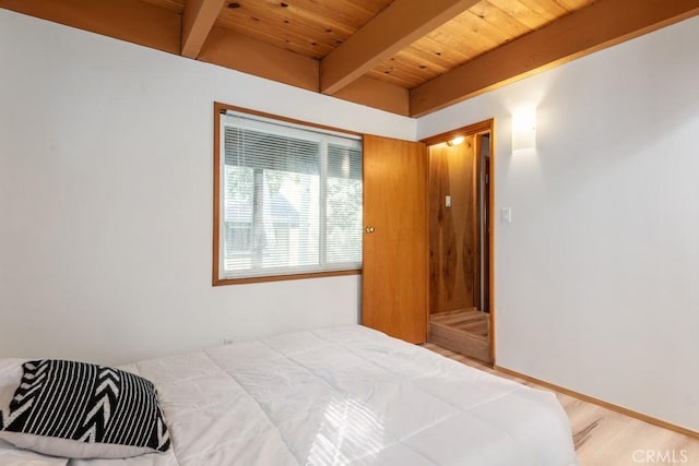 bedroom featuring wood ceiling, beam ceiling, and wood-type flooring