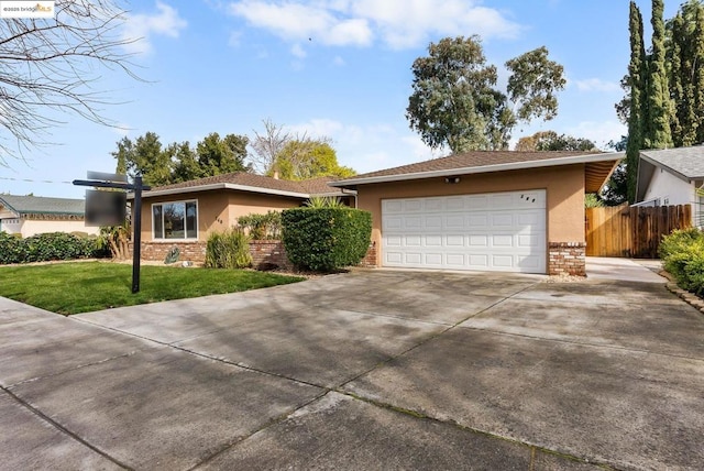 ranch-style house featuring a garage and a front yard