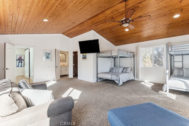 bedroom featuring vaulted ceiling, carpet, ensuite bathroom, and wooden ceiling