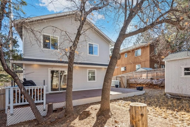 back of house with a wooden deck