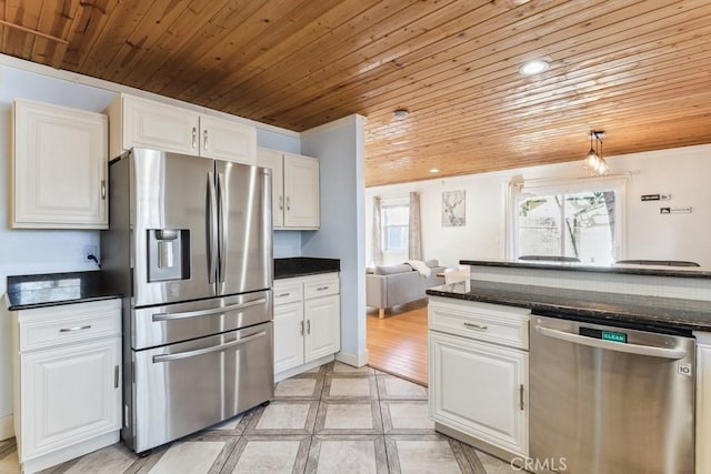 kitchen with appliances with stainless steel finishes, white cabinets, wood ceiling, and dark stone counters