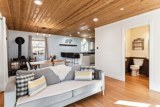 living room with rail lighting, sink, wooden ceiling, ornamental molding, and light hardwood / wood-style floors