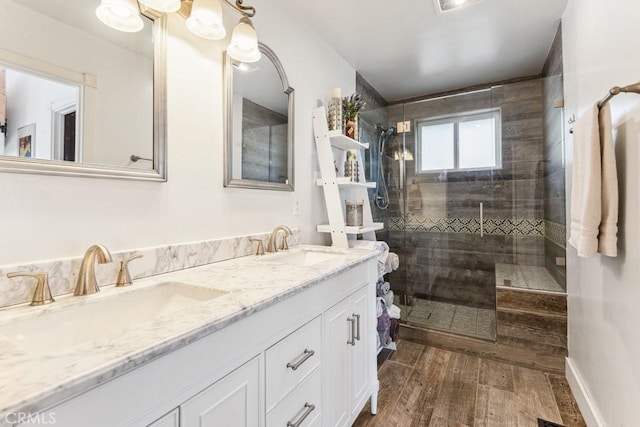 bathroom featuring a shower with door, vanity, and hardwood / wood-style flooring