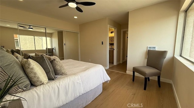 bedroom with a closet, ceiling fan, and light hardwood / wood-style flooring