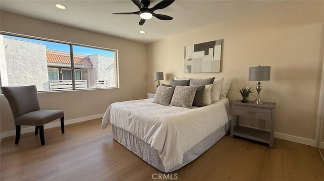 bedroom with ceiling fan and wood-type flooring