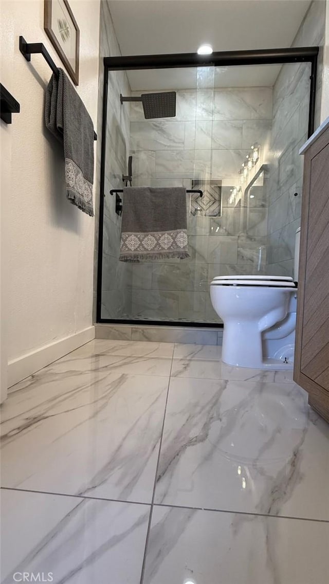 bathroom with toilet and a shower with door