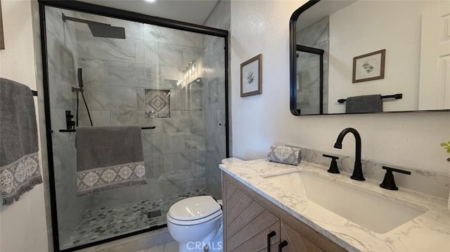 bathroom with vanity, toilet, and an enclosed shower