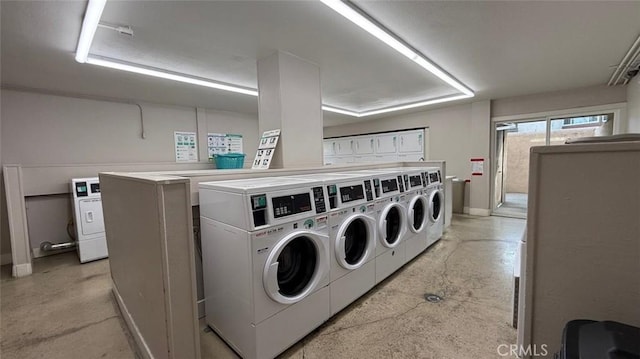 clothes washing area with washing machine and clothes dryer