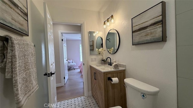 bathroom with vanity and toilet