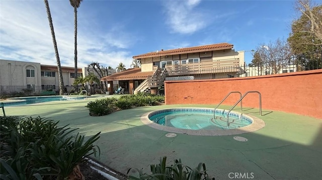 view of swimming pool featuring a community hot tub