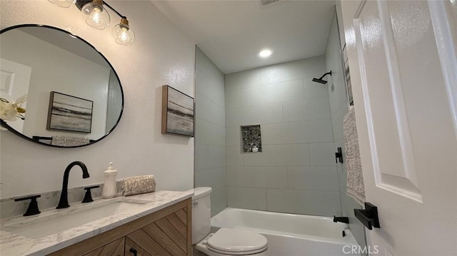 full bathroom with vanity, toilet, and tiled shower / bath combo