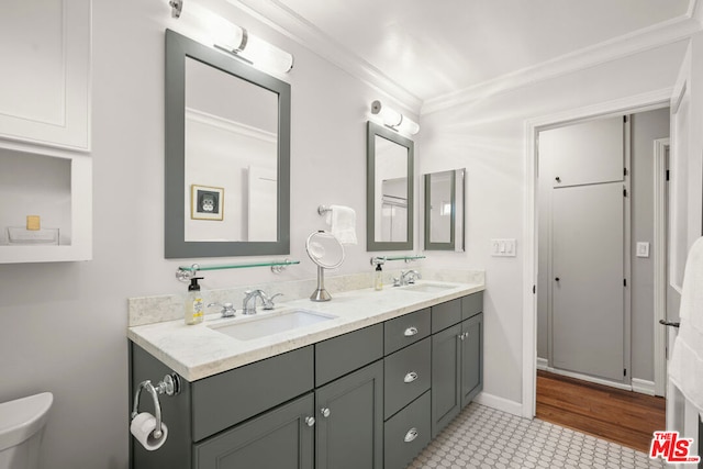 bathroom featuring ornamental molding, vanity, and toilet