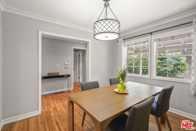 dining room featuring crown molding and light hardwood / wood-style flooring