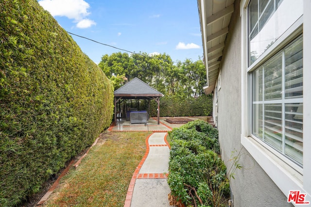 view of yard featuring a gazebo and a patio