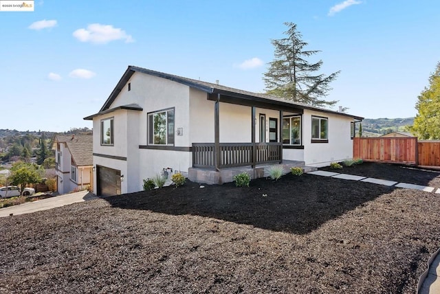 ranch-style home with a garage and covered porch