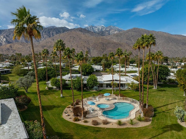 exterior space featuring a mountain view and a lawn