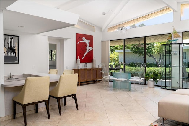 dining space featuring lofted ceiling, indoor wet bar, and light tile patterned floors