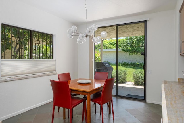 dining room featuring an inviting chandelier and tile patterned flooring