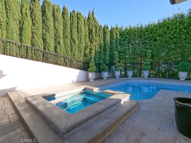 view of swimming pool featuring an in ground hot tub and a patio area