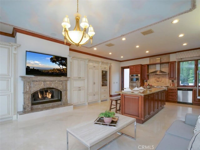 living room featuring crown molding, a notable chandelier, and a fireplace