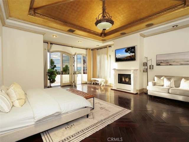 bedroom with parquet flooring, access to outside, ornamental molding, a tray ceiling, and a fireplace