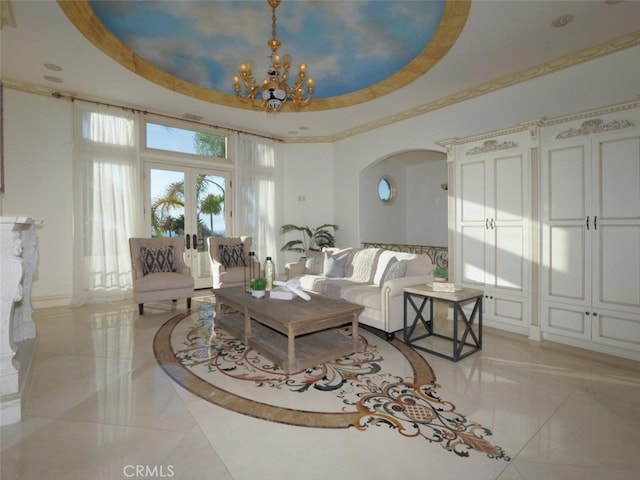 living room featuring french doors, a raised ceiling, and an inviting chandelier