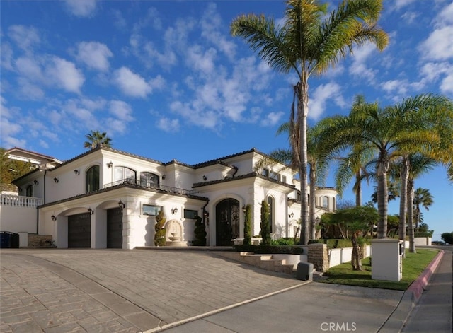 mediterranean / spanish home featuring a garage