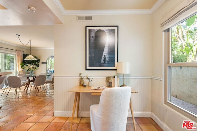 interior space with ornamental molding and light tile patterned floors