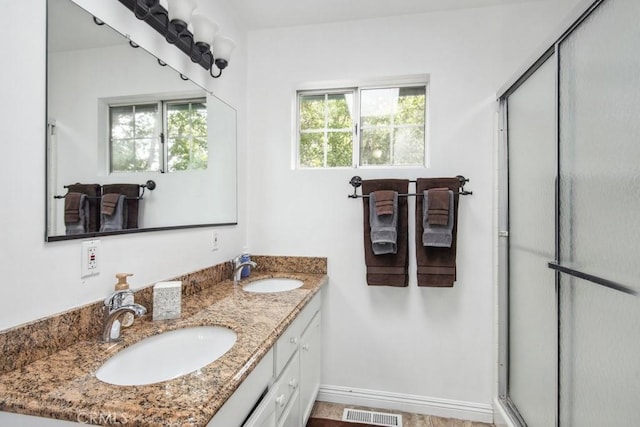 bathroom featuring vanity and a shower with shower door