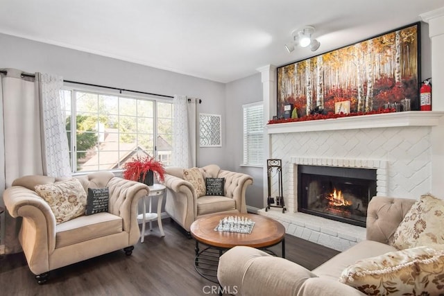 living room featuring hardwood / wood-style flooring and a brick fireplace