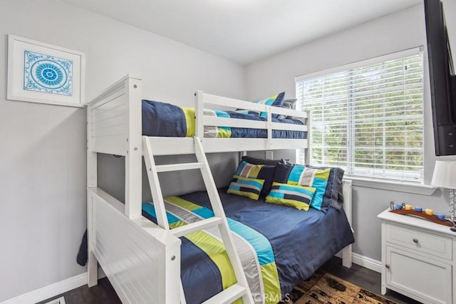 bedroom with dark wood-type flooring