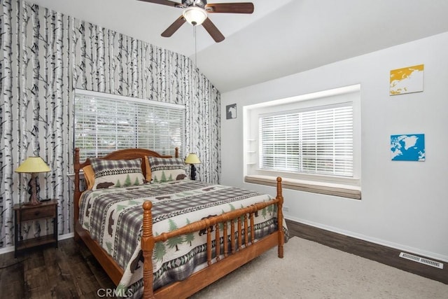 bedroom with ceiling fan, lofted ceiling, and dark hardwood / wood-style flooring