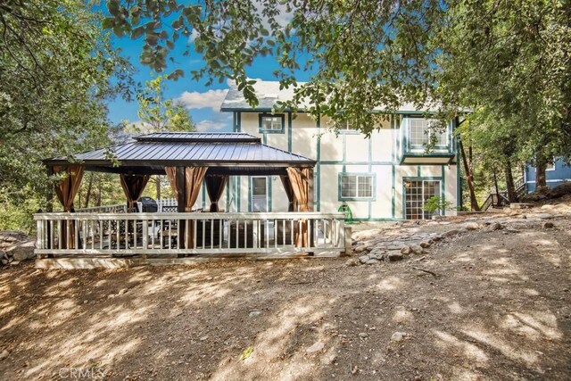 rear view of property featuring a gazebo