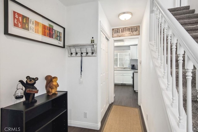 corridor with sink and dark hardwood / wood-style floors