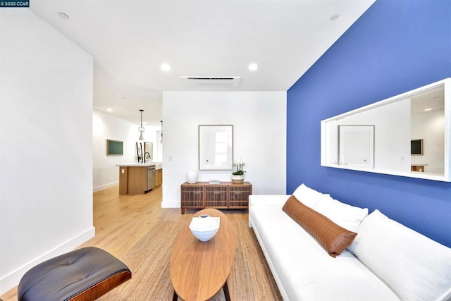 living room with sink and light hardwood / wood-style floors