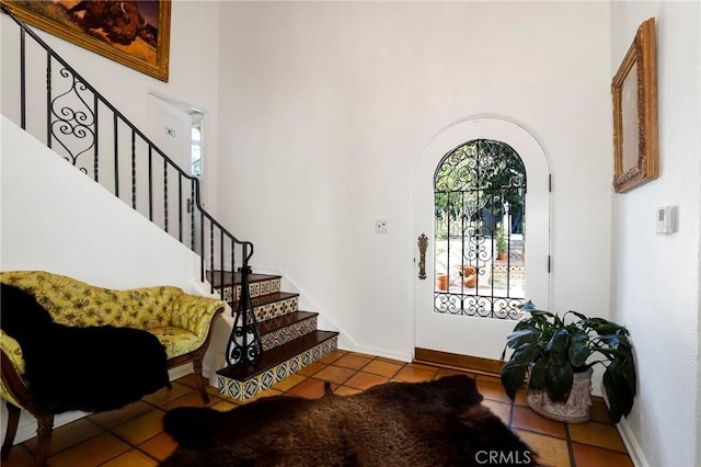 tiled entryway with a high ceiling