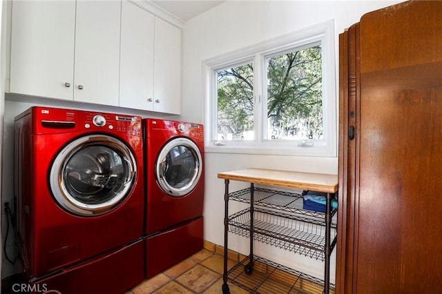 washroom featuring cabinets and washer and clothes dryer