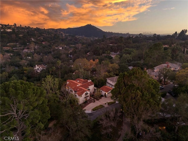 aerial view at dusk featuring a mountain view