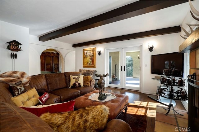 living room featuring hardwood / wood-style flooring, french doors, and beamed ceiling