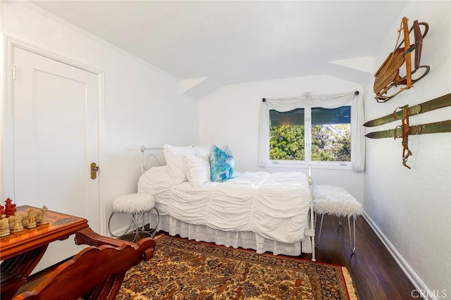 bedroom featuring vaulted ceiling and hardwood / wood-style floors