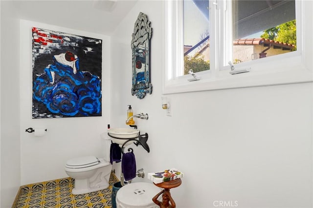 bathroom with toilet and tile patterned flooring