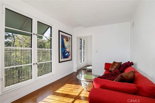 living room featuring a healthy amount of sunlight and dark hardwood / wood-style floors