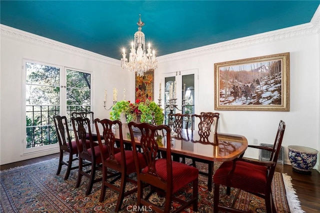 dining space with crown molding, dark hardwood / wood-style flooring, and a notable chandelier