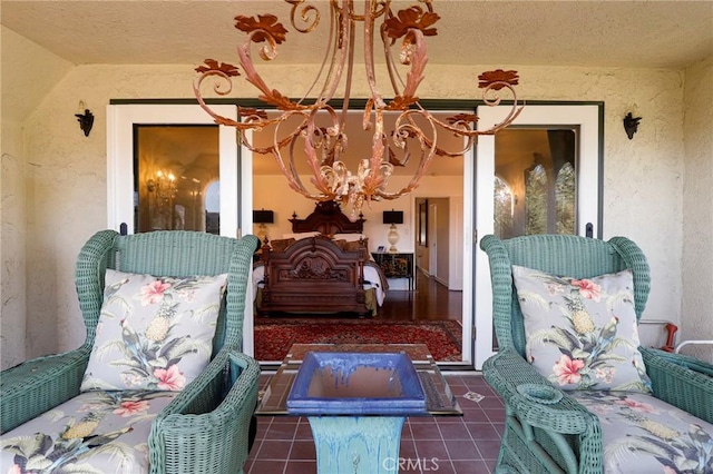 exterior space with a textured ceiling and an inviting chandelier