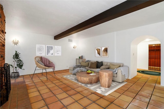 tiled living room with beamed ceiling