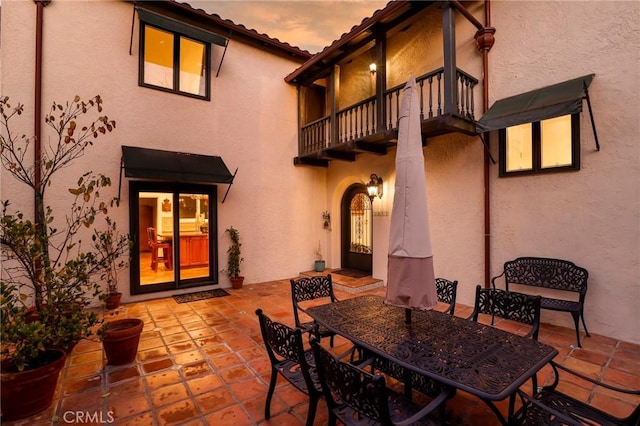 patio terrace at dusk with a balcony