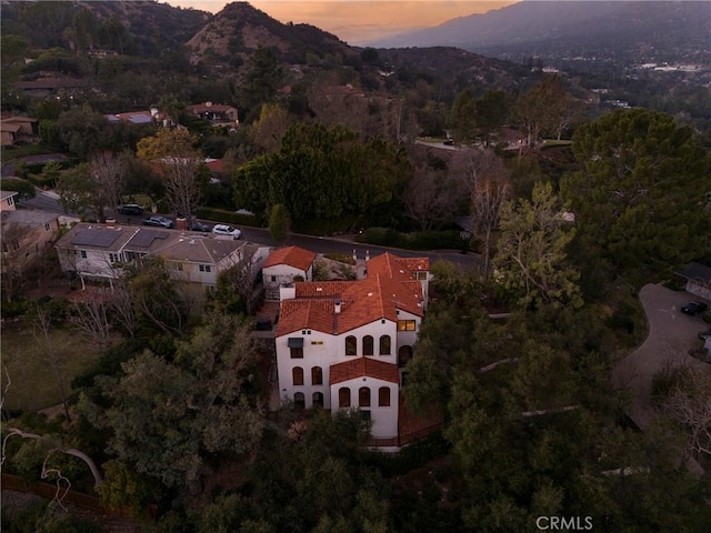 aerial view at dusk featuring a mountain view