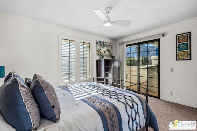 bedroom with ceiling fan, access to exterior, carpet floors, and a textured ceiling