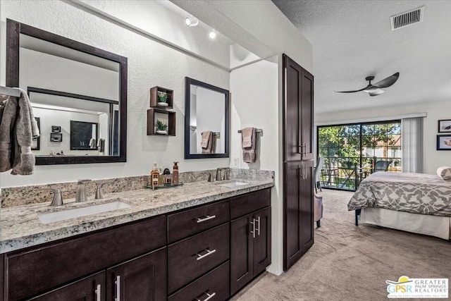 bathroom with ceiling fan and vanity