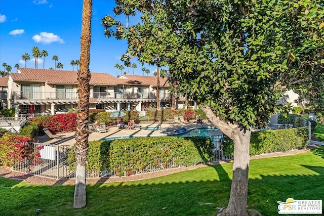 surrounding community featuring a yard, a swimming pool, and a patio